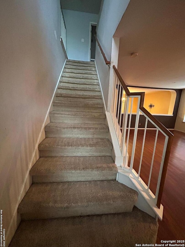 staircase with wood finished floors