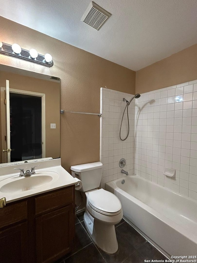 bathroom with visible vents, tile patterned floors, vanity, toilet, and washtub / shower combination