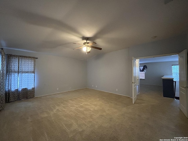unfurnished bedroom with baseboards, light carpet, and ceiling fan