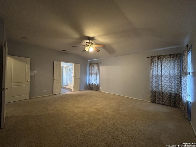 carpeted empty room featuring baseboards and ceiling fan