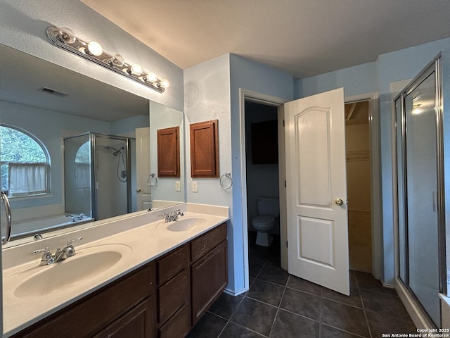 full bathroom with visible vents, a sink, a stall shower, and tile patterned flooring