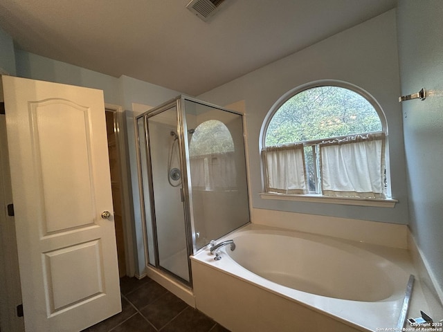 full bathroom featuring tile patterned floors, a garden tub, a stall shower, and visible vents