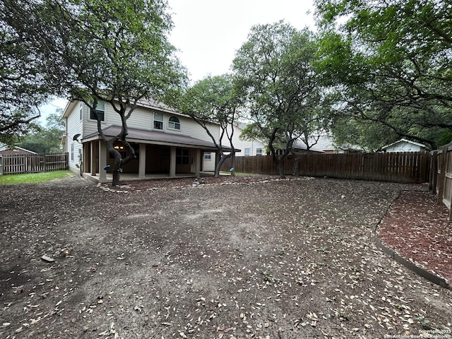 view of yard with a fenced backyard and covered porch