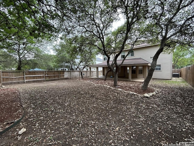 view of yard with a porch and a fenced backyard