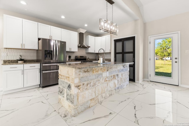 18262 Maureen Path, Lytle, TX 78052 - kitchen featuring stainless steel appliances, wall chimney exhaust hood, tasteful backsplash, dark stone countertops, and light marble finish floors