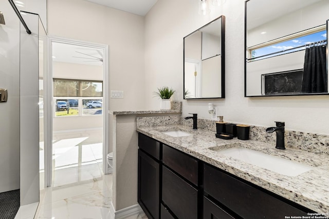 18262 Maureen Path, Lytle, TX 78052 - full bath with marble tiled floors, double vanity, and a shower