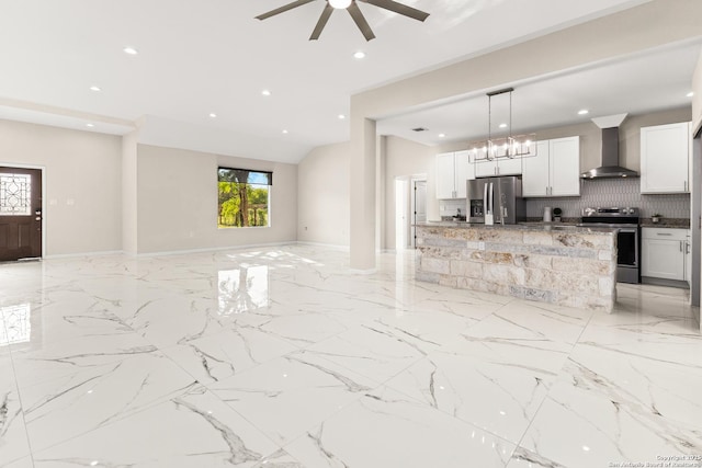 18262 Maureen Path, Lytle, TX 78052 - kitchen featuring stainless steel appliances, wall chimney exhaust hood, open floor plan, backsplash, and hanging light fixtures