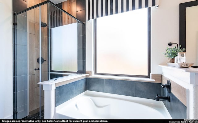 bathroom with a garden tub and a stall shower