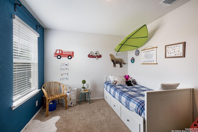 carpeted bedroom featuring baseboards and visible vents