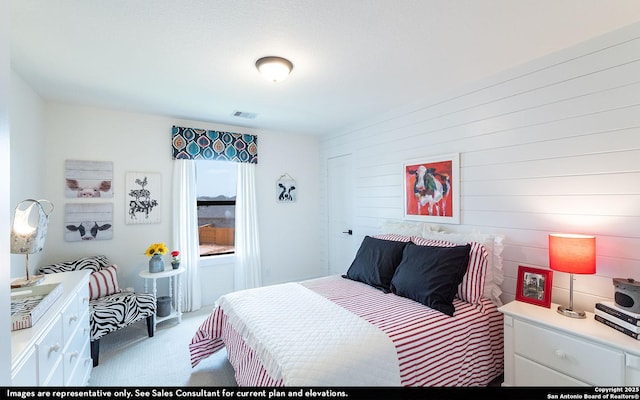 bedroom with light colored carpet and visible vents