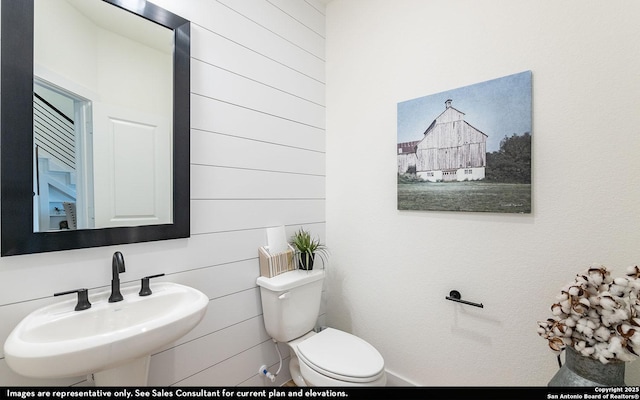 half bath with toilet and a sink
