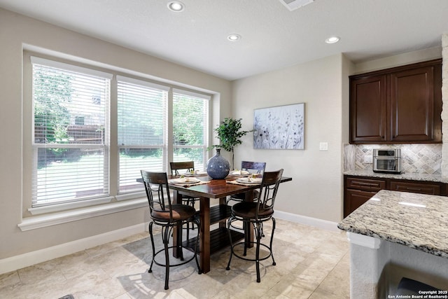dining space featuring healthy amount of natural light, recessed lighting, and baseboards
