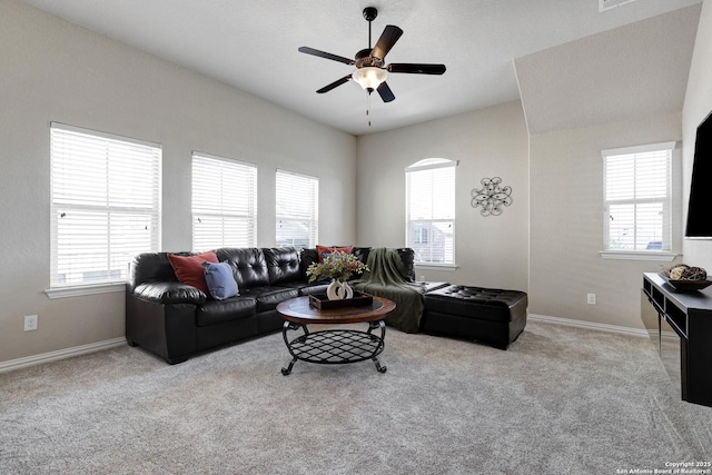 living room featuring a ceiling fan, healthy amount of natural light, and carpet