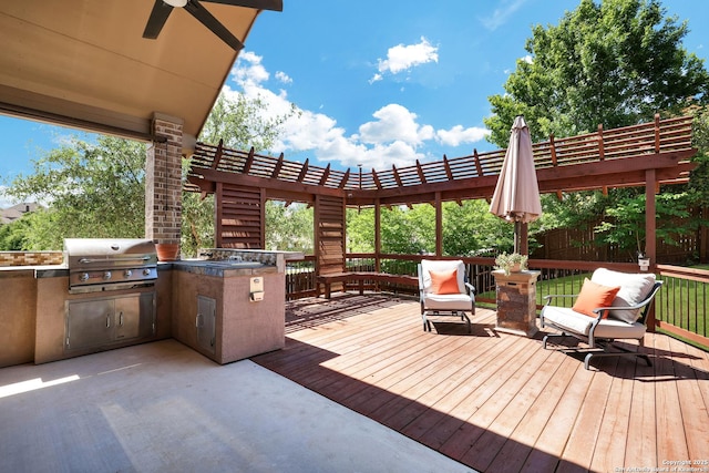 wooden terrace featuring a grill, area for grilling, a pergola, and ceiling fan