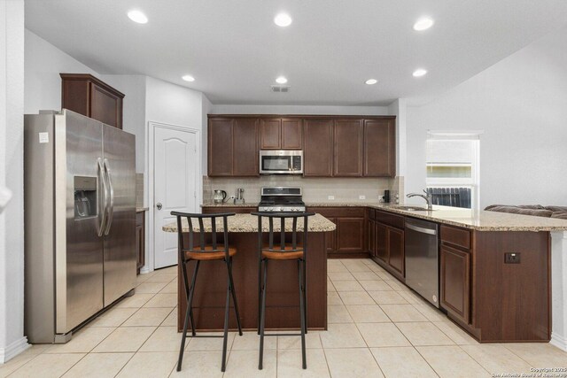 6772 Concho, Schertz, TX 78108 - kitchen featuring light stone counters, tasteful backsplash, dark brown cabinets, and stainless steel appliances