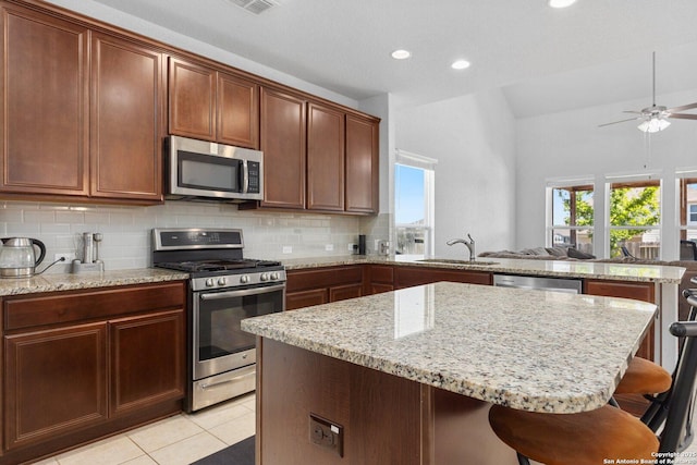 6772 Concho, Schertz, TX 78108 - kitchen with a center island, tasteful backsplash, a sink, stainless steel appliances, and a peninsula