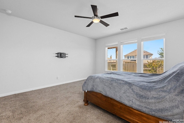 bedroom featuring carpet floors, a ceiling fan, visible vents, and baseboards