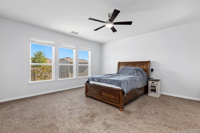 bedroom featuring carpet, visible vents, baseboards, and ceiling fan