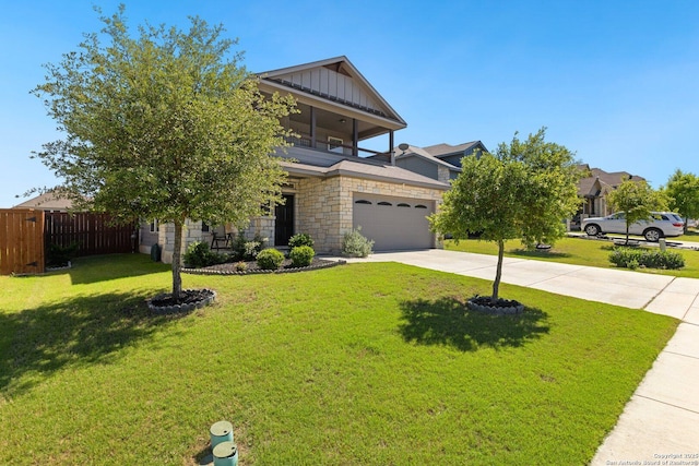 6772 Concho, Schertz, TX 78108 - view of front of house featuring fence, a front lawn, concrete driveway, board and batten siding, and stone siding
