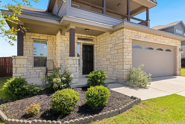 6772 Concho, Schertz, TX 78108 - view of exterior entry featuring concrete driveway, stone siding, and a balcony