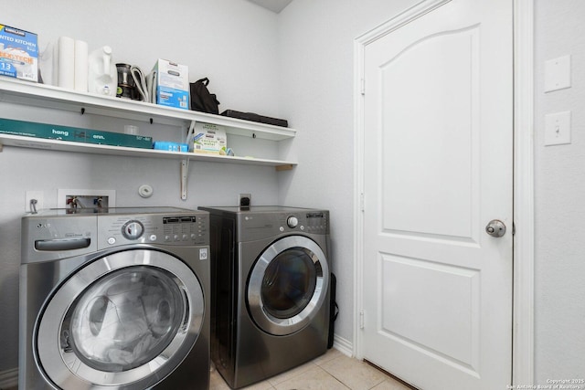 laundry room featuring washing machine and dryer, laundry area, and light tile patterned floors