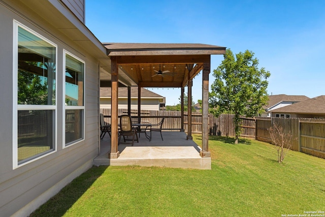view of yard featuring a ceiling fan, a patio area, and a fenced backyard