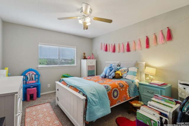 carpeted bedroom with baseboards and ceiling fan