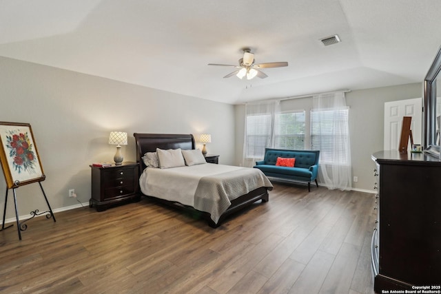 bedroom with baseboards, wood finished floors, visible vents, and ceiling fan