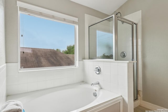 full bath featuring a bath and a stall shower