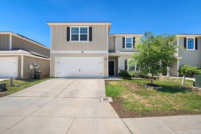 view of front of house featuring driveway, board and batten siding, a front yard, and an attached garage