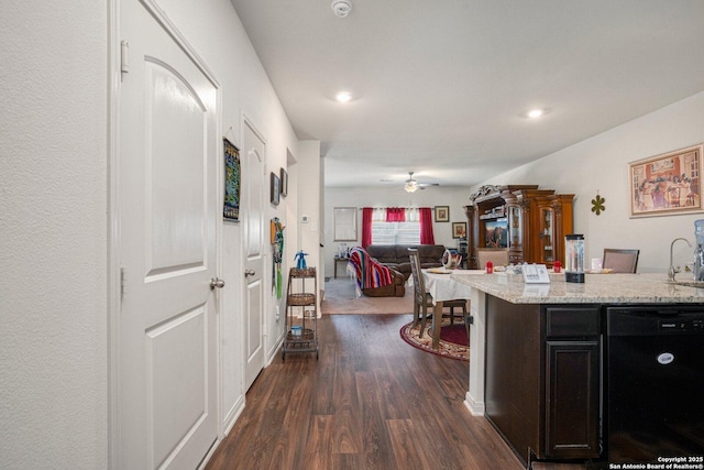 kitchen featuring light stone counters, dark wood-style floors, open floor plan, dishwasher, and recessed lighting