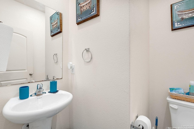 bathroom with toilet and a sink