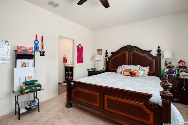 bedroom with visible vents, ensuite bathroom, baseboards, light carpet, and a ceiling fan