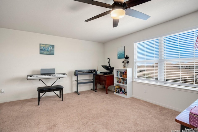 interior space with carpet flooring, ceiling fan, and baseboards