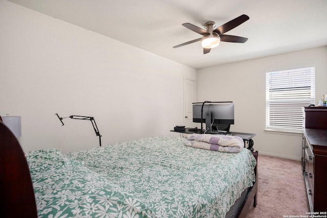 bedroom with baseboards, ceiling fan, and light colored carpet