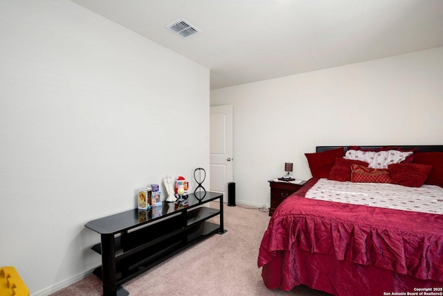 bedroom with visible vents, baseboards, and light carpet