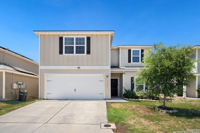 traditional-style home with board and batten siding, a front lawn, driveway, and an attached garage