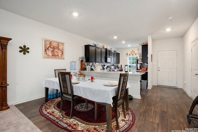 dining space with recessed lighting, dark wood finished floors, and baseboards