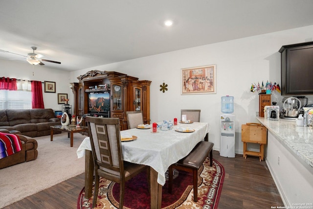 dining space featuring ceiling fan and dark wood finished floors