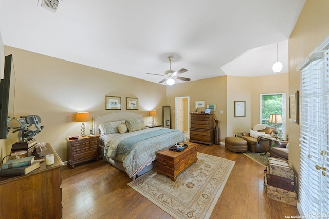 bedroom with dark wood-style floors, a ceiling fan, and visible vents