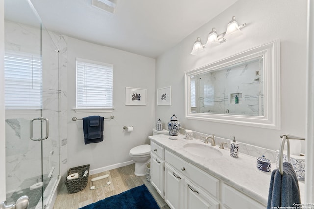 full bath featuring wood finished floors, visible vents, toilet, vanity, and a marble finish shower
