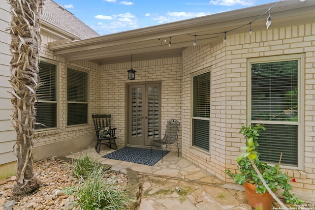 doorway to property featuring brick siding