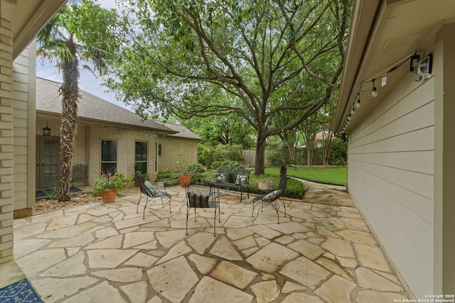 view of patio / terrace featuring fence