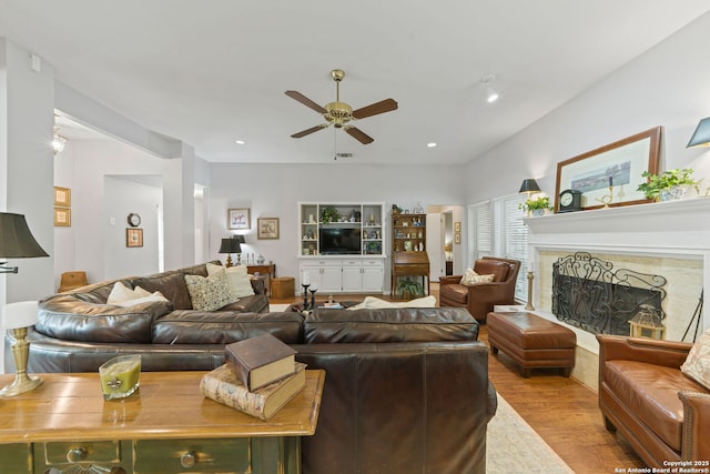 living area with recessed lighting, wood finished floors, visible vents, a fireplace, and ceiling fan