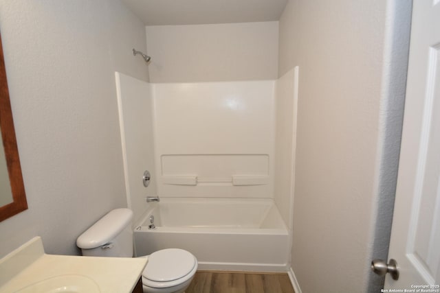 bathroom featuring tub / shower combination, wood finished floors, toilet, and vanity