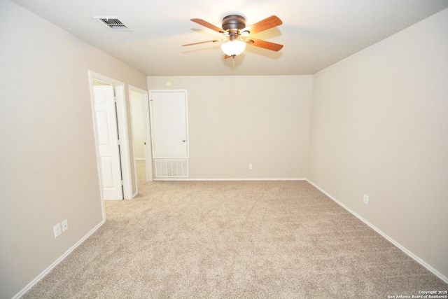 unfurnished room with a ceiling fan, visible vents, and carpet floors