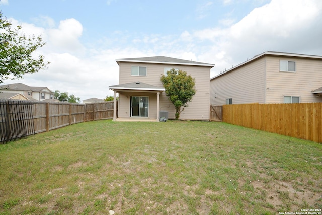 back of house featuring a patio area, a lawn, central AC, and a fenced backyard