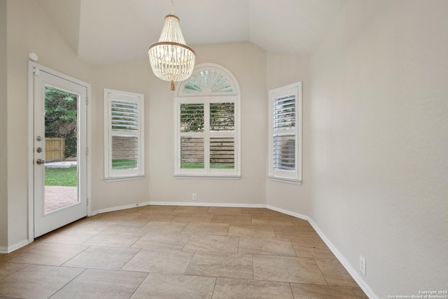 unfurnished dining area featuring baseboards, a notable chandelier, and lofted ceiling