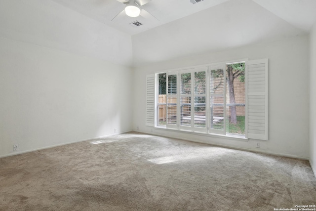 carpeted empty room featuring ceiling fan, visible vents, a wealth of natural light, and vaulted ceiling