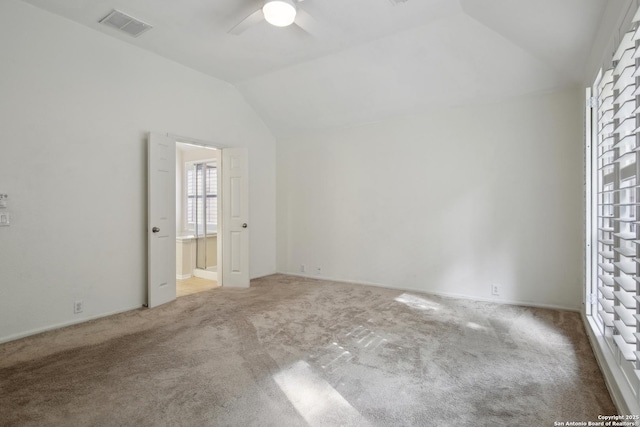 22010 Dolomite, San Antonio, TX 78259 - unfurnished bedroom with carpet flooring, visible vents, vaulted ceiling, and connected bathroom